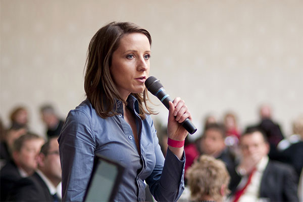 woman asking question with microphone